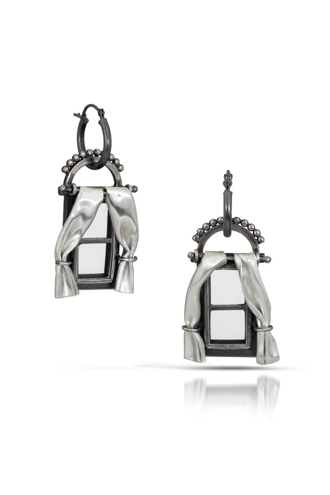 A pair of one of a kind statement window shaped earrings with small rectangle panels and sweeping curtains. Oxidized sterling silver with crystal quartz for window panels, and fine silver sheet for curtains.