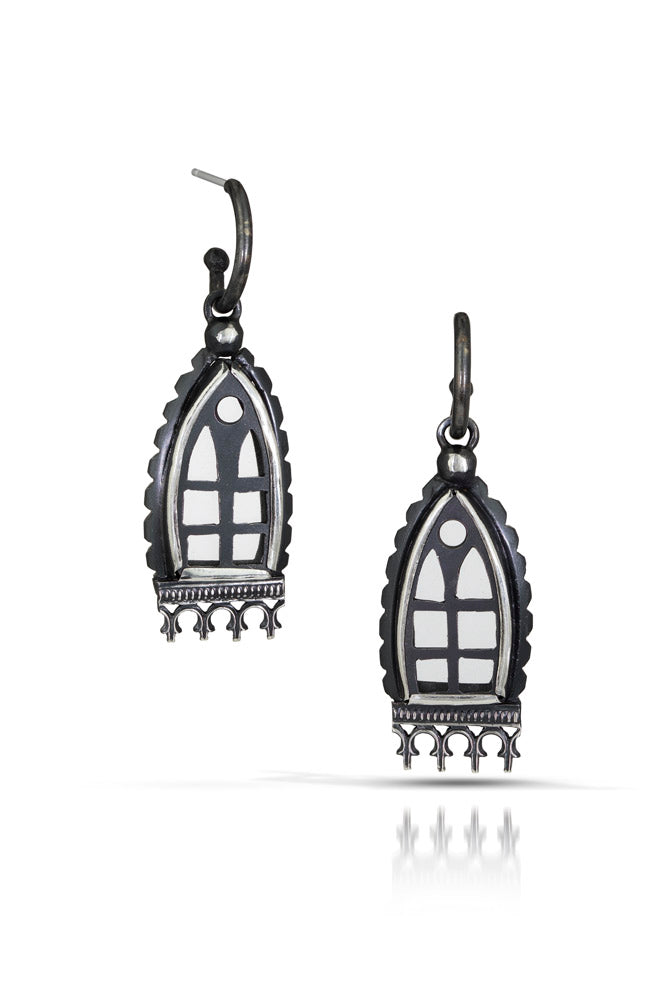 A pair of one of a kind statement window shaped earrings with small arch panels and decorative elements framing the windows. Oxidized sterling silver with crystal quartz for window panels.