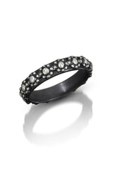Oxidized sterling silver band with continuous floral wreath motif against blackened finish, for daily use.