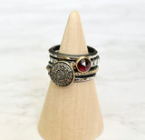 A set of 5 rings, one with 10mm pavé diamond disc set into 14k gold bezel with 14k beaded oxidized sterling silver band, one 6mm rose cut garnet set into 14k gold bezel with hammered oxidized sterling silver beaded band, one skinny triangle oxidized and highlighted sterling silver band separating the two stone rings, sandwiching both ends are two heavy hammered oxidized sterling silver bands, for a decorative classic look to complete your outfit.