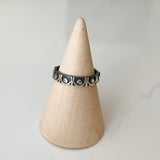 Oxidized silver ring band with continuous shiny silver trellis motif relief against blackened finish for everyday use as well as for special occasions such as wedding, engagement, birthdays, mother's day, and holidays.